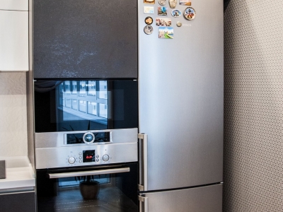отдельно стоящий холодильник гармонично вписан в пенальную конструкцию